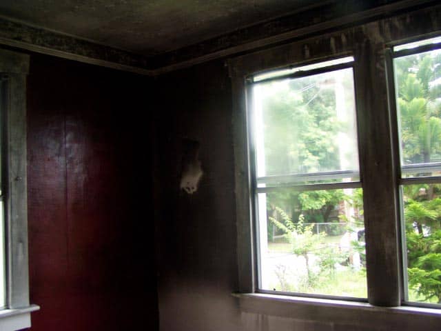 corner of a room covered in soot from a house fire