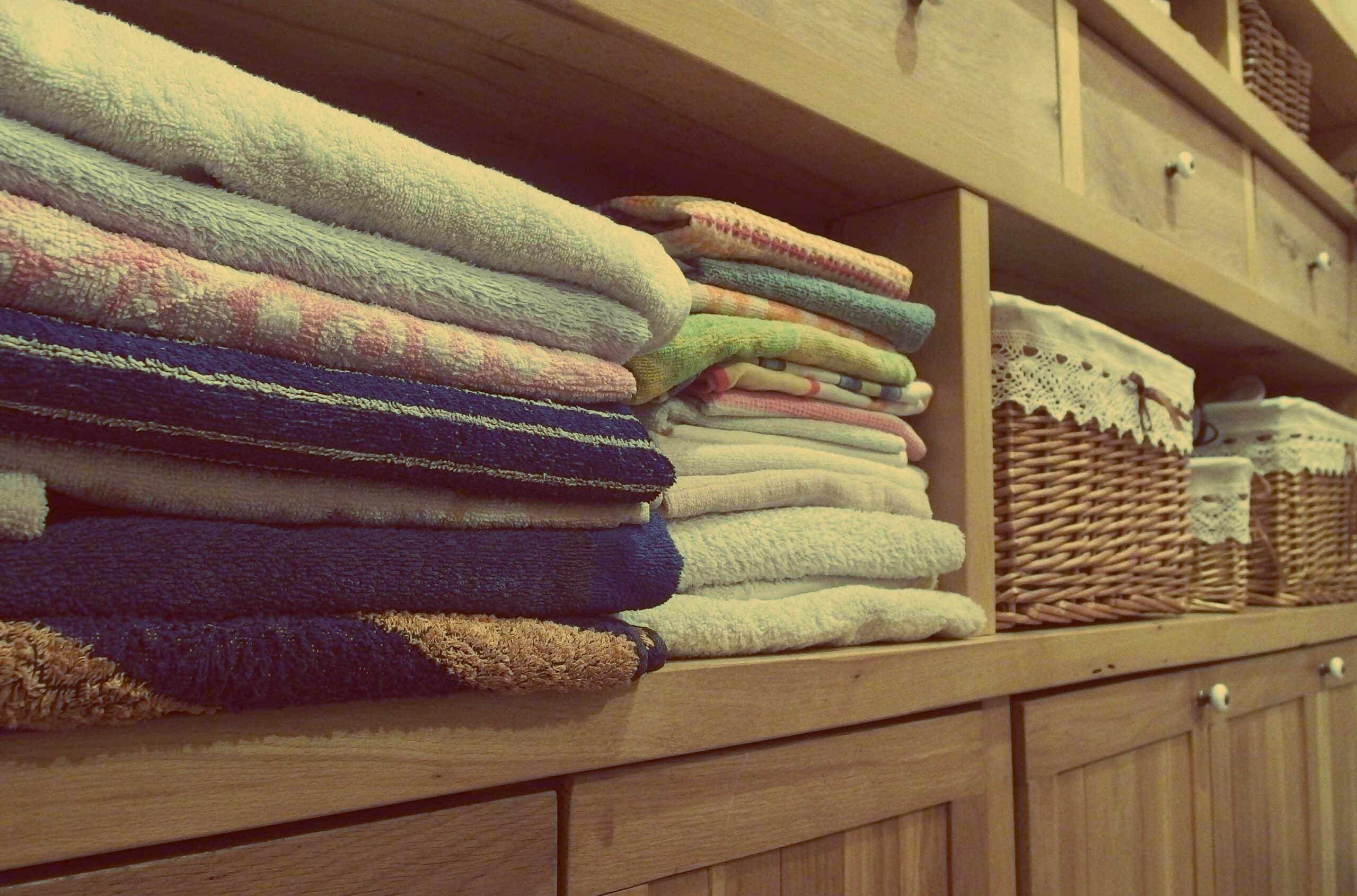 folded towels in a cabinet cleaner laundry