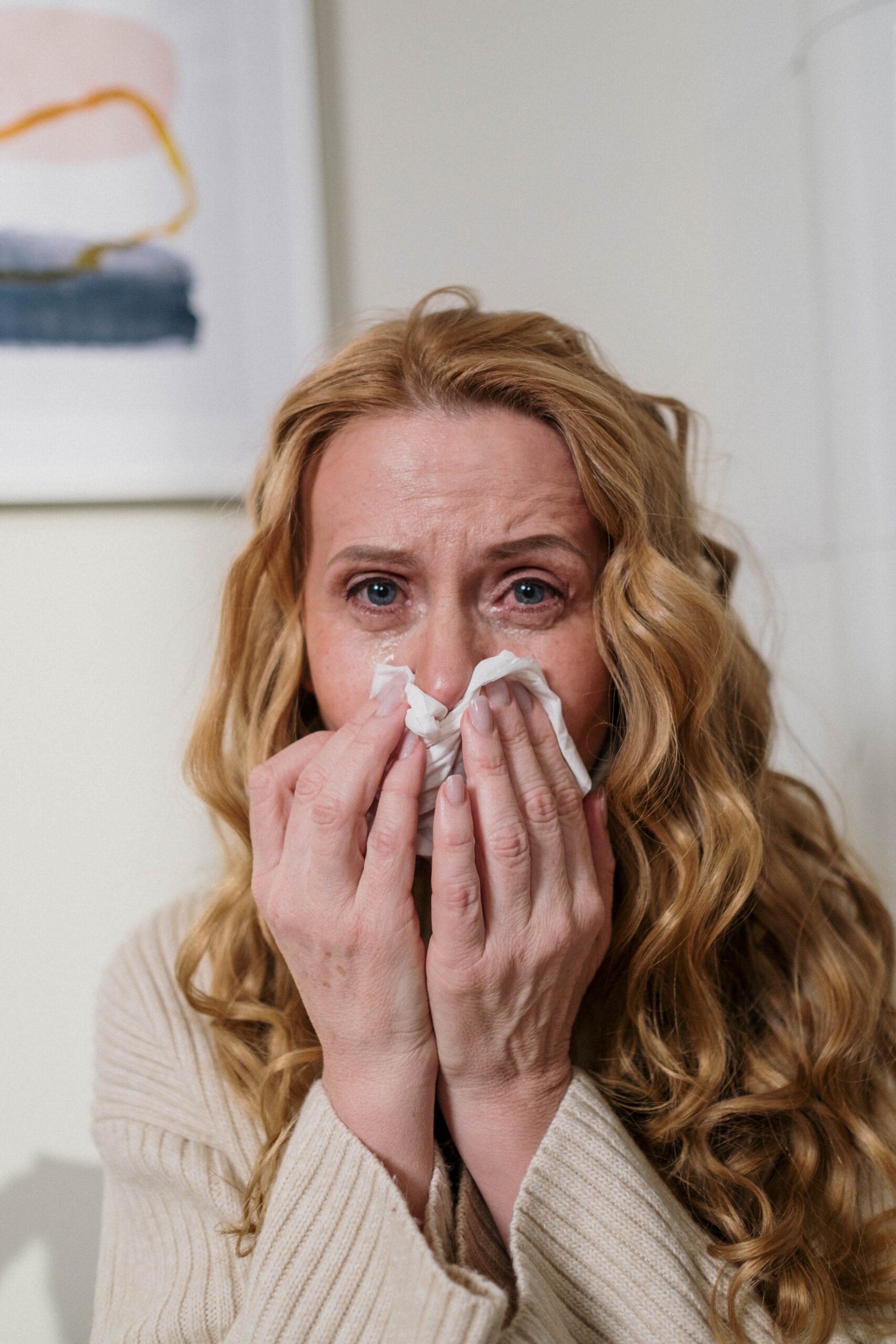 woman after sneezing due to allergens carpets better for allergies