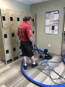 man using machine to clean carpets