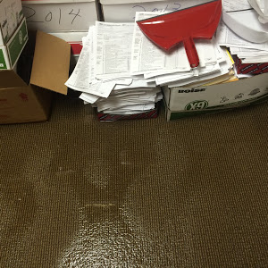water flooding a carpeted floor with cardboard boxes of documents water extraction