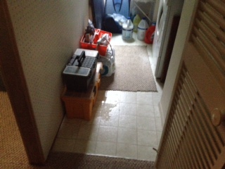 water intrusion into a hallway with boxes on the floor